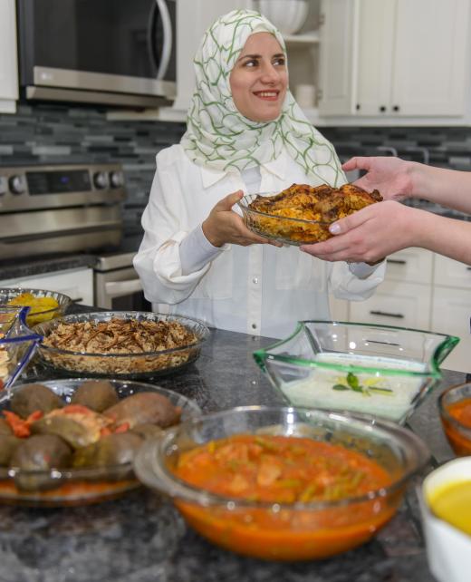 Aya Murad smiling while sharing a freshly prepared dish
